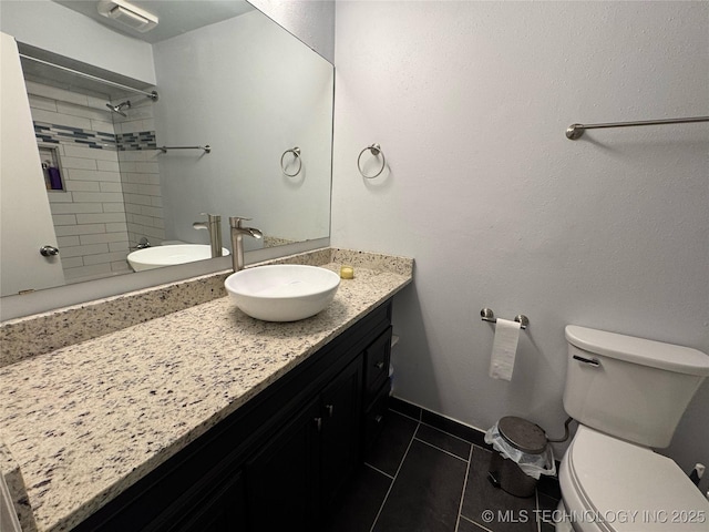 4302 E 67th St Unit 656, Tulsa, OK 74136 - bathroom featuring toilet, tile patterned floors, a shower, vanity, and baseboards