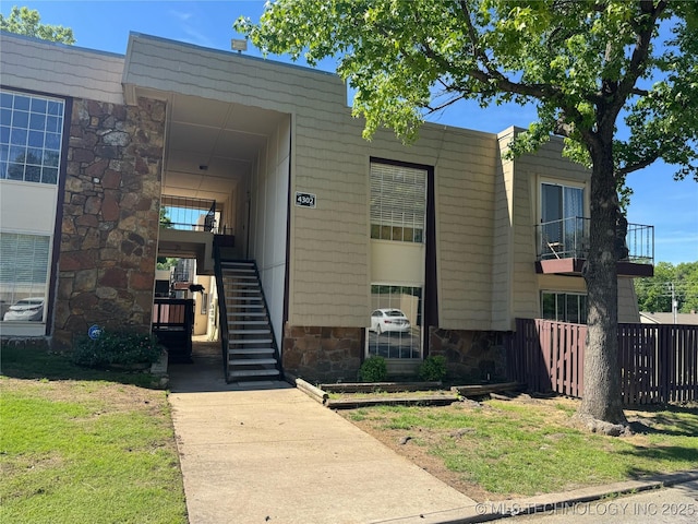 4302 E 67th St Unit 656, Tulsa, OK 74136 - view of front facade featuring stairs and stone siding
