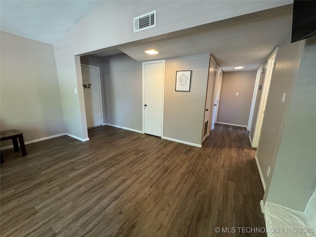 4302 E 67th St Unit 656, Tulsa, OK 74136 - empty room featuring dark wood-style floors, baseboards, and vaulted ceiling