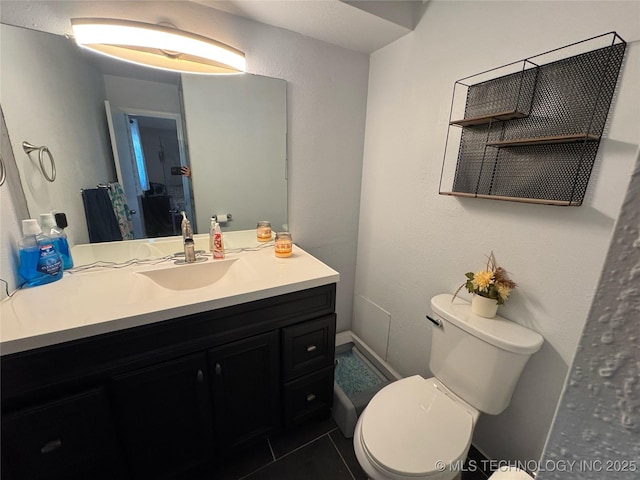 4302 E 67th St Unit 656, Tulsa, OK 74136 - bathroom featuring toilet, tile patterned floors, and vanity