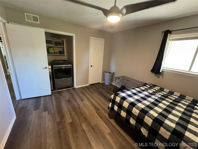 4302 E 67th St Unit 656, Tulsa, OK 74136 - bedroom featuring washer / clothes dryer, dark wood finished floors, a ceiling fan, and baseboards
