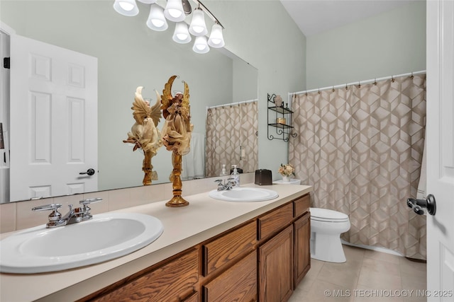 813 Franklin, Ardmore, OK 73401 - bathroom with double vanity, toilet, tile patterned floors, a chandelier, and a shower with shower curtain