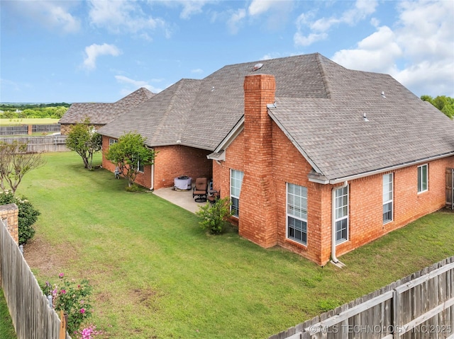 813 Franklin, Ardmore, OK 73401 - back of property with brick siding, a chimney, a patio, and roof with shingles