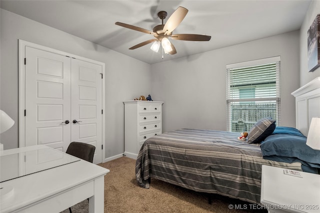 carpeted bedroom featuring a ceiling fan, baseboards, and a closet