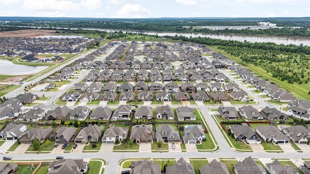 aerial view of property's location with a nearby body of water and nearby suburban area