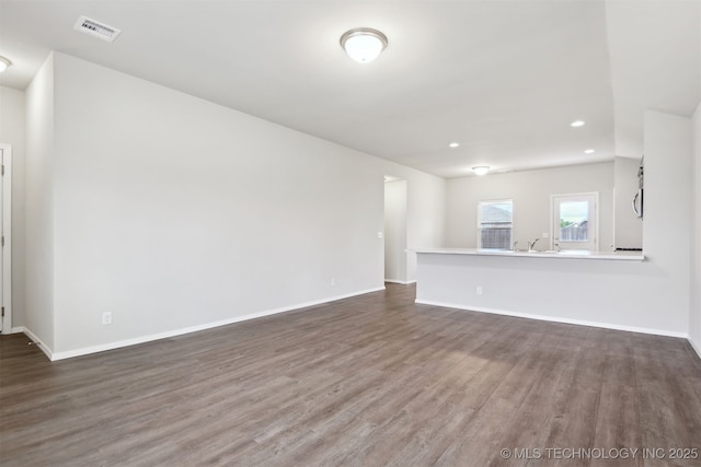 7535 E 158th St S, Bixby, OK 74008 - unfurnished living room with wood finished floors, baseboards, and recessed lighting