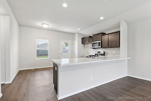 7535 E 158th St S, Bixby, OK 74008 - kitchen featuring appliances with stainless steel finishes, dark brown cabinetry, a peninsula, dark wood-type flooring, and baseboards