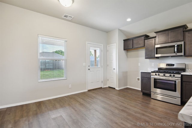 7535 E 158th St S, Bixby, OK 74008 - kitchen with appliances with stainless steel finishes, light countertops, dark brown cabinets, dark wood finished floors, and recessed lighting