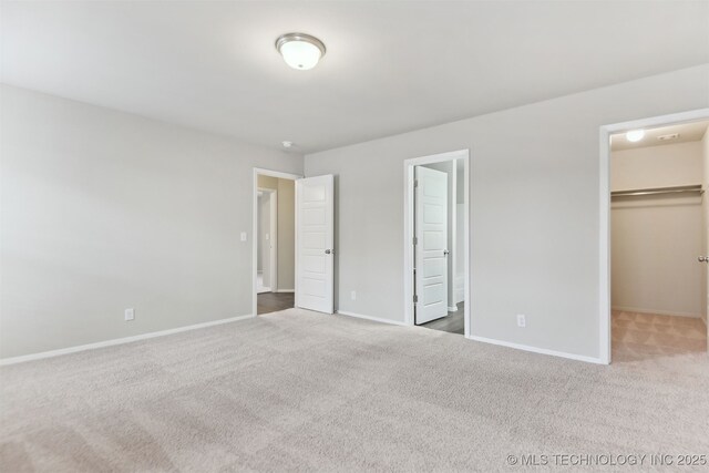 7535 E 158th St S, Bixby, OK 74008 - unfurnished bedroom featuring carpet, baseboards, and a walk in closet
