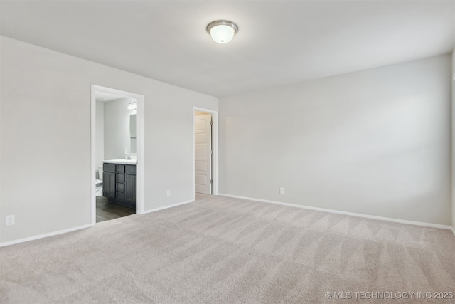 7535 E 158th St S, Bixby, OK 74008 - unfurnished bedroom featuring carpet floors, baseboards, a sink, and ensuite bathroom