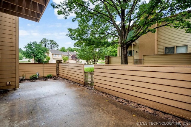 view of patio / terrace featuring fence and a gate