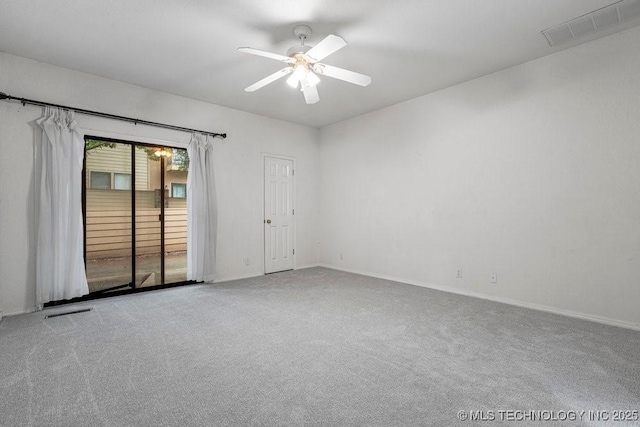 unfurnished room with carpet floors, a ceiling fan, and baseboards