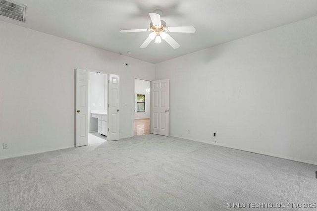unfurnished bedroom with light carpet, connected bathroom, ceiling fan, and baseboards