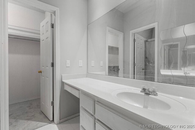 bathroom with vanity, a shower, and tile patterned flooring