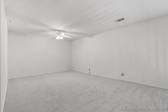 empty room with a ceiling fan, carpet, and baseboards