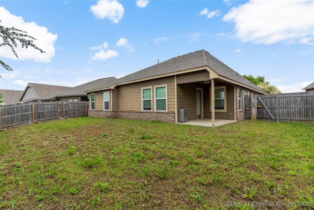 rear view of property featuring a patio area and brick siding