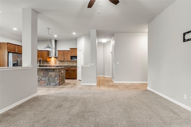unfurnished living room featuring light colored carpet, a ceiling fan, recessed lighting, baseboards, and light tile patterned floors