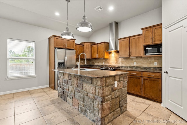 kitchen with wall chimney range hood, a sink, black microwave, brown cabinets, and lofted ceiling