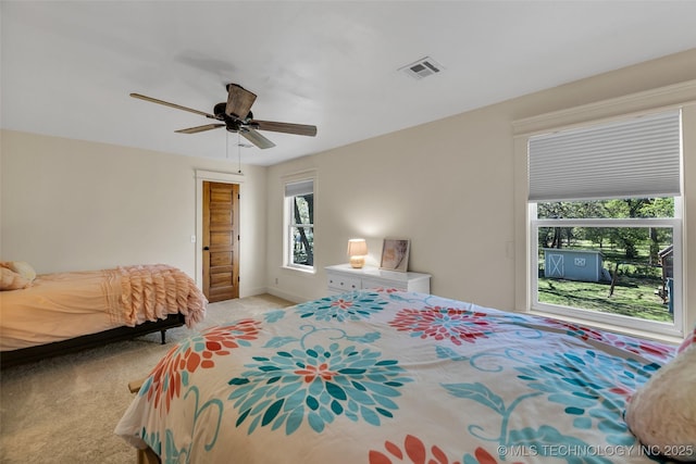 bedroom with light colored carpet, a ceiling fan, and baseboards