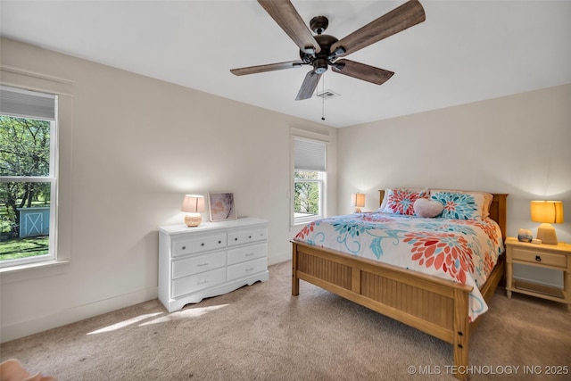 bedroom with multiple windows, carpet floors, ceiling fan, and baseboards