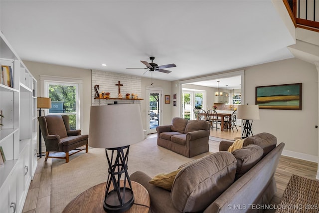 living room featuring light wood-style flooring, a ceiling fan, baseboards, and recessed lighting