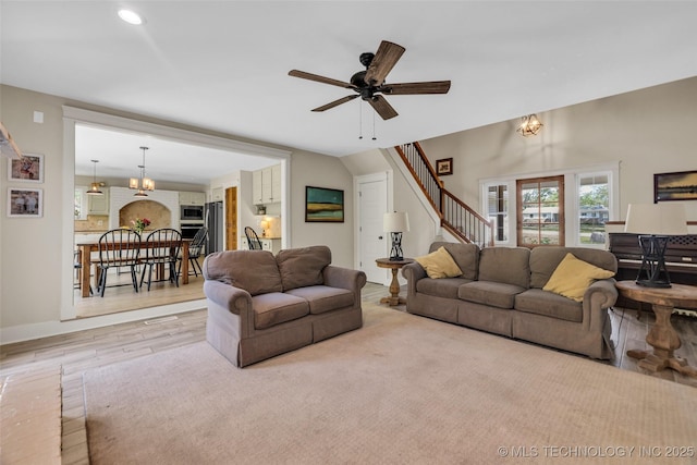 living room featuring stairway, ceiling fan, wood finished floors, and recessed lighting
