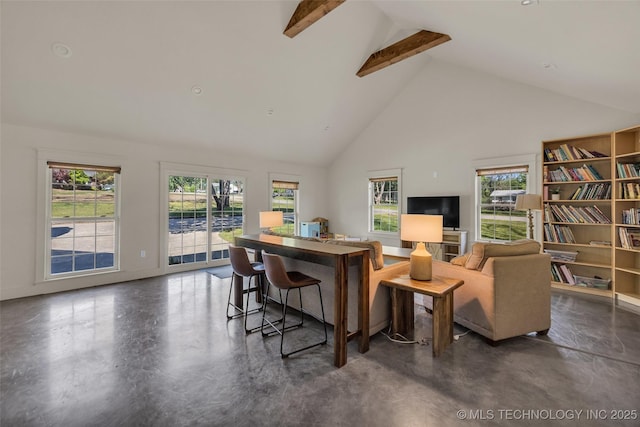 living room featuring high vaulted ceiling, finished concrete floors, healthy amount of natural light, beamed ceiling, and baseboards