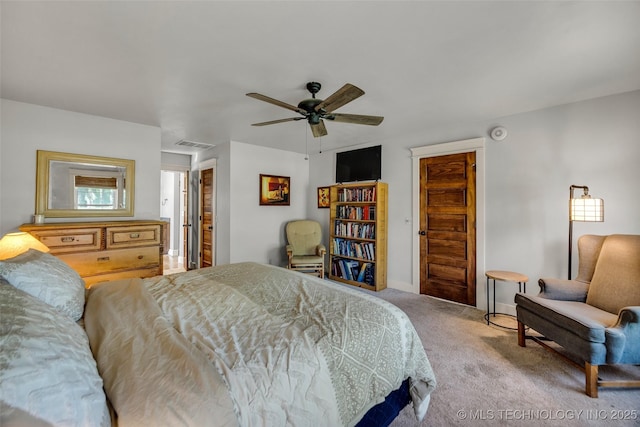 carpeted bedroom with baseboards and a ceiling fan
