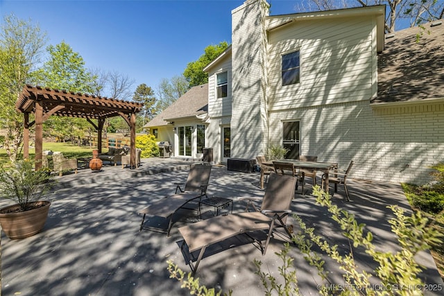 view of patio / terrace with a pergola and outdoor dining area