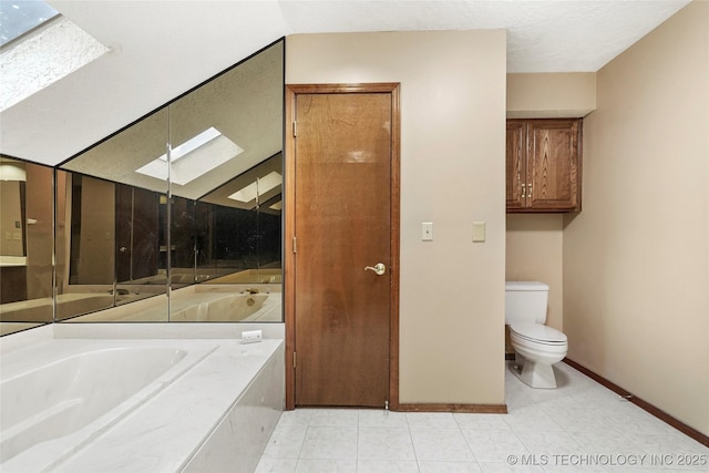full bath featuring a skylight, toilet, a bath, and baseboards