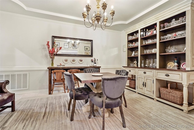 dining space with a chandelier and crown molding