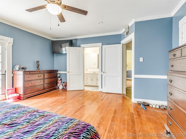 2831 S 24th St W, Muskogee, OK 74401 - bedroom with ornamental molding, light wood finished floors, a ceiling fan, ensuite bathroom, and baseboards