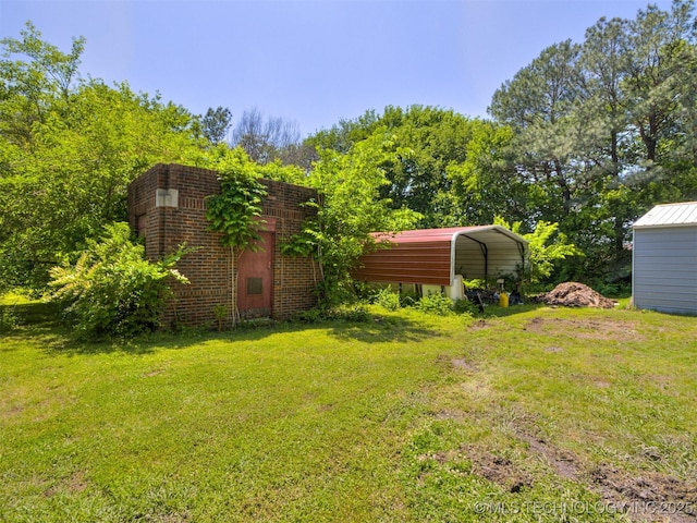 2831 S 24th St W, Muskogee, OK 74401 - view of grassy yard with a carport