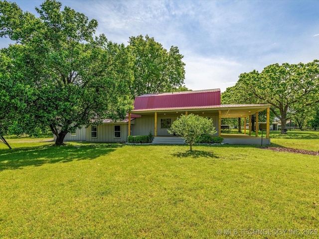 view of front facade featuring a carport, a front lawn, metal roof, and board and batten siding