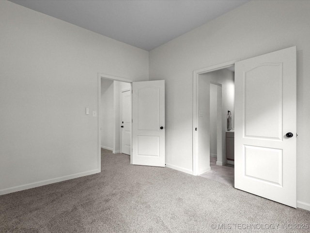 unfurnished bedroom featuring carpet and baseboards