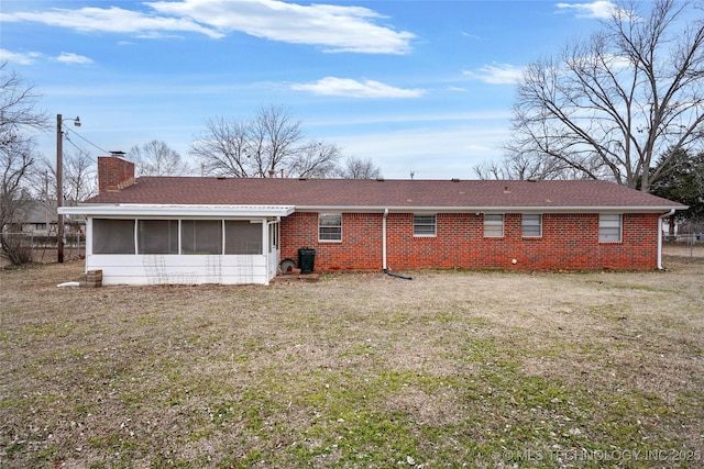 1601 S 165th W Ave, Sand Springs, OK 74063 - rear view of house featuring a sunroom, a chimney, a lawn, brick siding, and a shingled roof