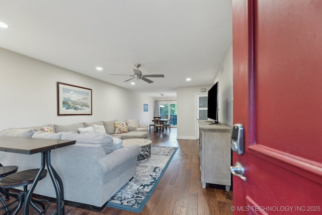 living room featuring a ceiling fan, recessed lighting, and dark wood finished floors