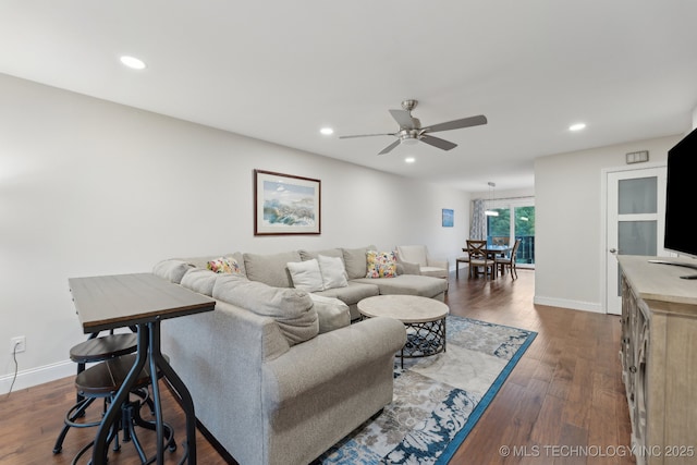 living room featuring a ceiling fan, recessed lighting, baseboards, and dark wood-style floors