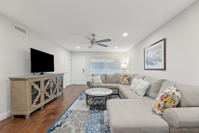 living room featuring dark wood-type flooring, baseboards, a ceiling fan, and recessed lighting