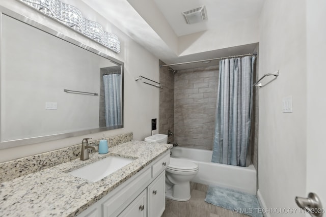 bathroom with shower / bath combo with shower curtain, vanity, and toilet
