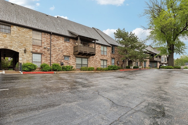 view of property with uncovered parking and a residential view
