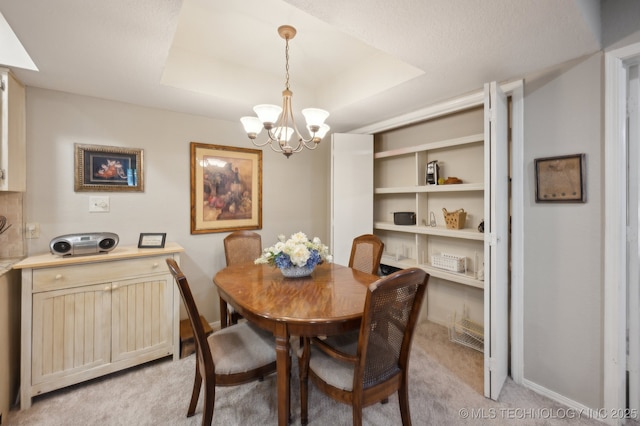6522 S Memorial Dr Unit 19-H, Tulsa, OK 74133 - dining area with a chandelier, light carpet, a tray ceiling, and baseboards