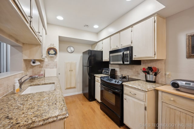 6522 S Memorial Dr Unit 19-H, Tulsa, OK 74133 - kitchen with black appliances, a sink, tasteful backsplash, light wood-type flooring, and recessed lighting