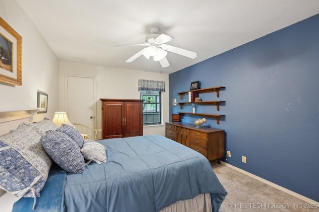 6522 S Memorial Dr Unit 19-H, Tulsa, OK 74133 - bedroom with carpet floors, ceiling fan, and baseboards