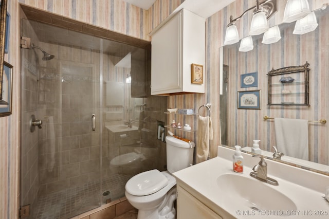 6522 S Memorial Dr Unit 19-H, Tulsa, OK 74133 - bathroom with wallpapered walls, toilet, vanity, and a stall shower