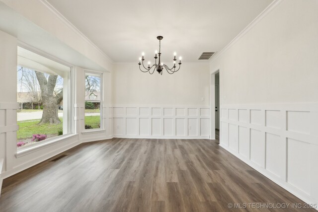 1901 W Indianola St, Broken Arrow, OK 74012 - unfurnished dining area featuring a chandelier, ornamental molding, wood finished floors, a decorative wall, and a wainscoted wall