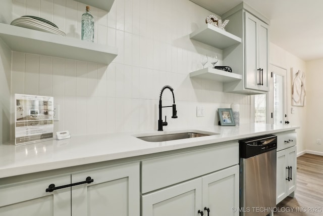 1901 W Indianola St, Broken Arrow, OK 74012 - kitchen featuring open shelves, stainless steel dishwasher, a sink, light countertops, and wood finished floors