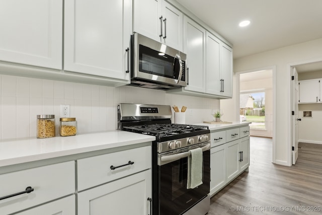 1901 W Indianola St, Broken Arrow, OK 74012 - kitchen featuring stainless steel appliances, backsplash, light countertops, light wood-style floors, and recessed lighting