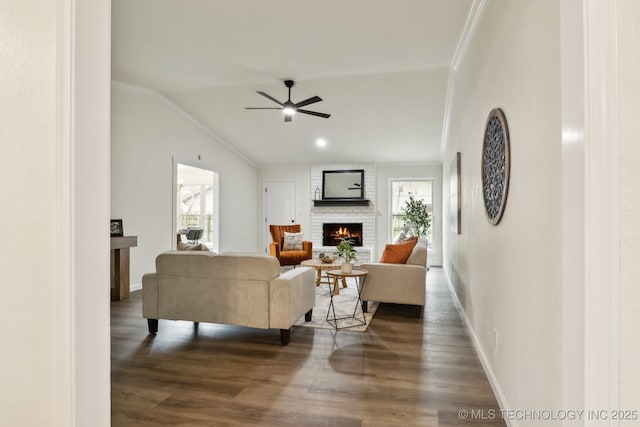 1901 W Indianola St, Broken Arrow, OK 74012 - living area with ornamental molding, a brick fireplace, healthy amount of natural light, a ceiling fan, and dark wood finished floors