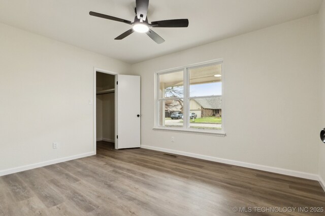 1901 W Indianola St, Broken Arrow, OK 74012 - unfurnished bedroom with wood finished floors, baseboards, and a ceiling fan
